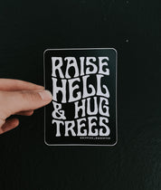Raise hell & hug trees // sticker